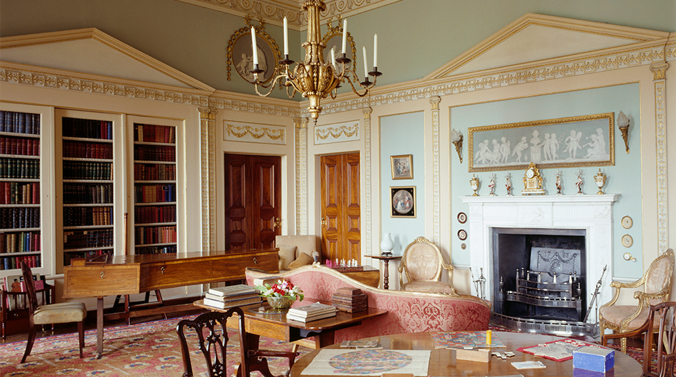 The Library at Berrington Hall has fitted bookcases designed to resemble classical facades with shallow pediments & delicate Ionic pilasters united by a frieze of square Greek key pattern.